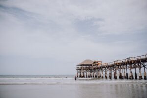 a group of people standing on top of a pier